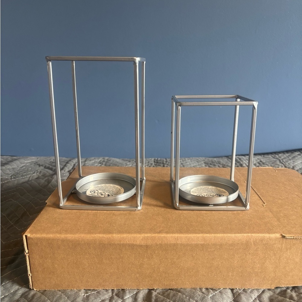 Set Of 2 Metal Candle Holders. Open rectangle holder at bottom.